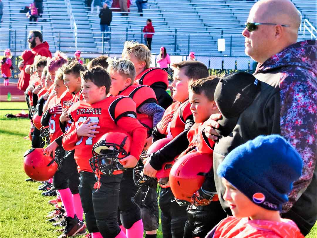 Football Players Standing for National Anthem
